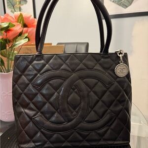 CHANEL  Medallion in black caviar leather Silver Charm